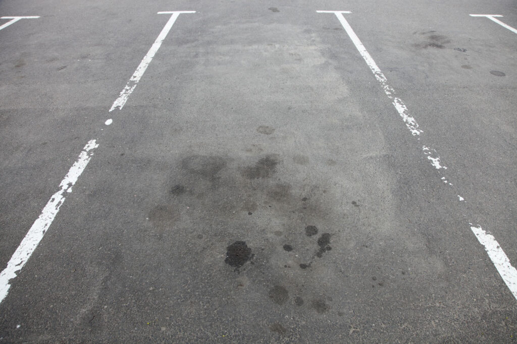 grease stains on asphalt of a parking lot